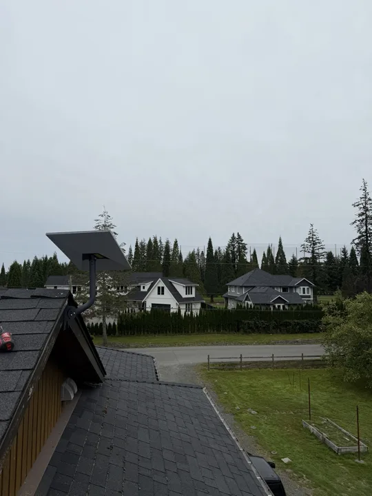 Starlink dish on a roof mount overlooking neighbouring homes