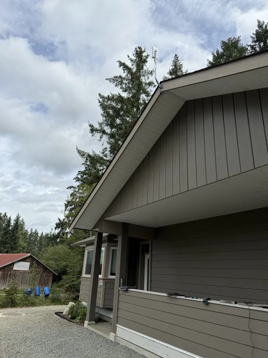 Starlink dish mounted above the gable of a house